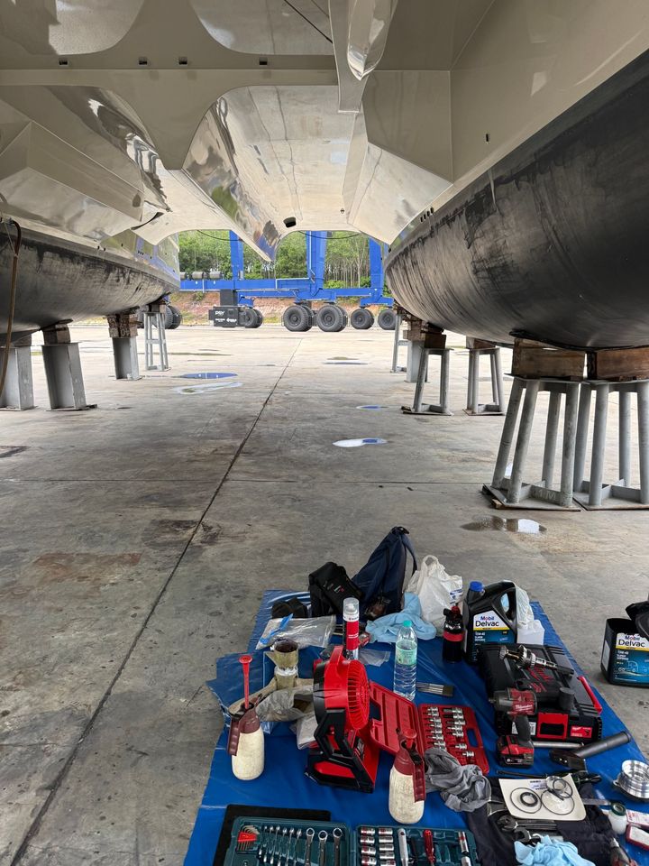Tools laid out between the hulls with the travel lift behind
